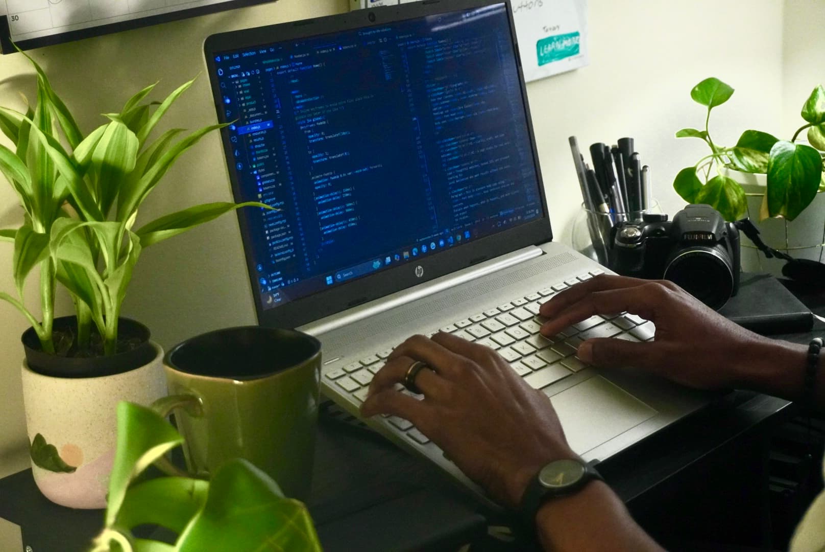 Hands working at a laptop—craft in motion.